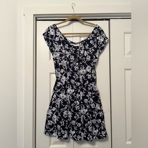 Int’l navy dress with white floral pattern. Buttons in front. Size 8.